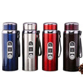 Four insulated stainless steel water bottles in blue, silver, red, and dark brown, arranged side by side on a white background.
